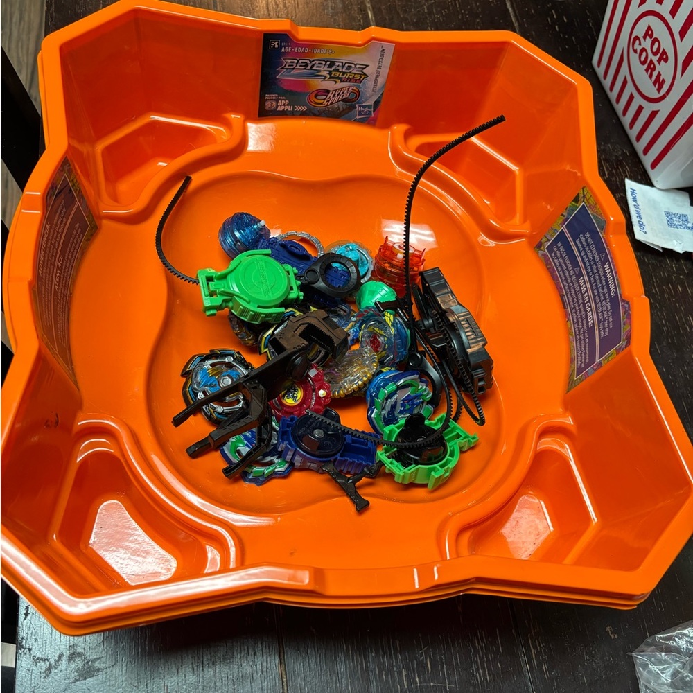 Hasbro Orange Beyblade Battle Arena with Multicolor Tops and Launchers